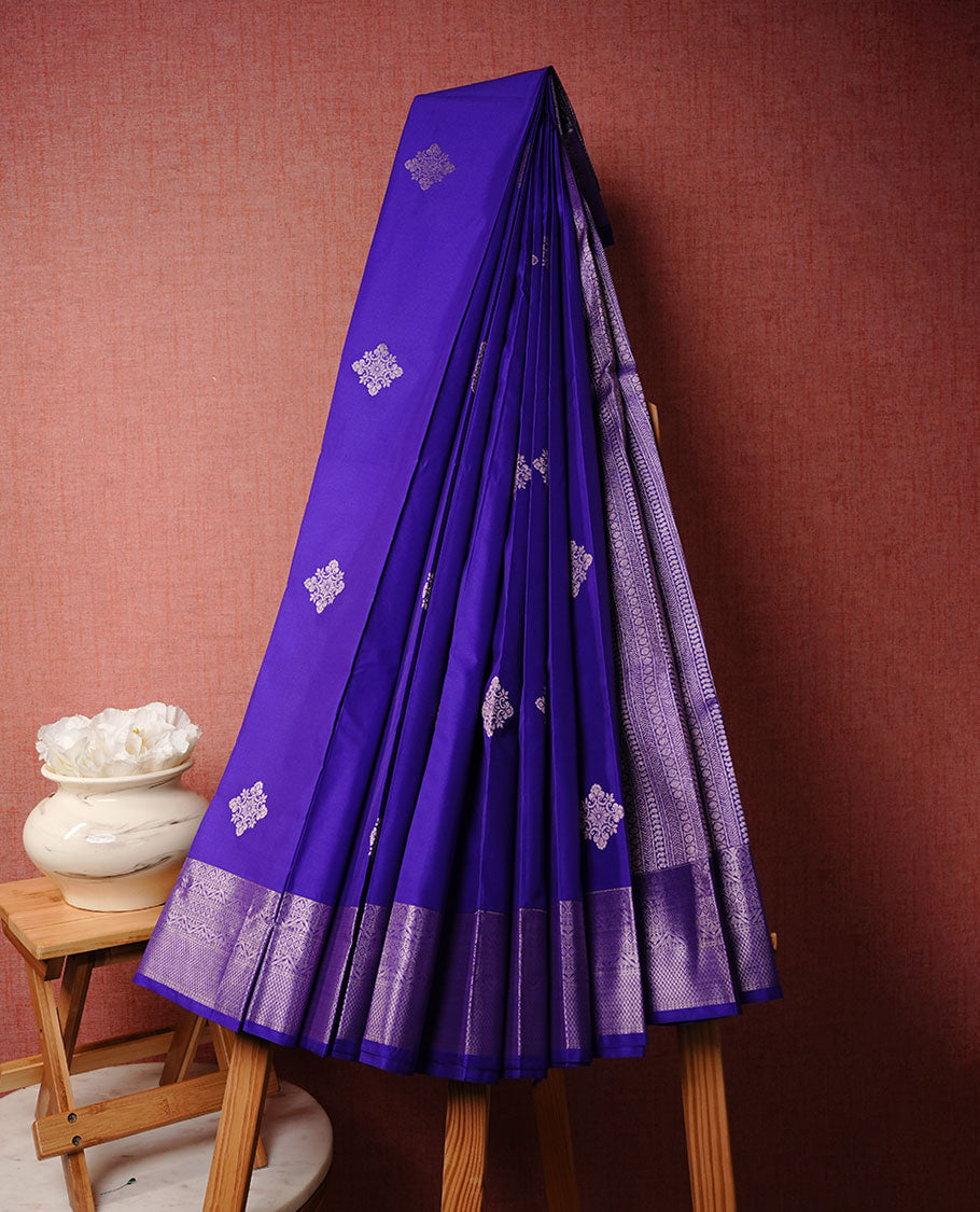 Indigo colour soft silk saree featuring rose Gold zari motifs on body, complemented by self colour with traditional border, paired with matching blouse piece.