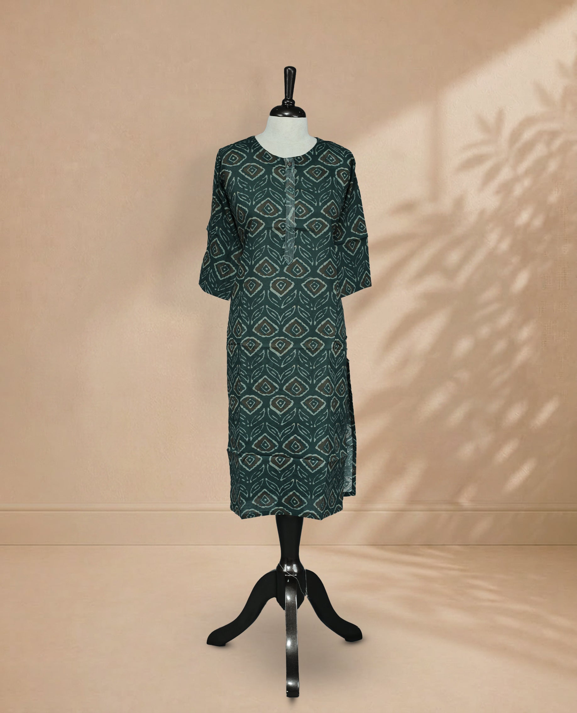 Dark Teal Colour Kurti Faturing  geometric and leaf-inspired block print On Body , Round  Neckline  With Thread Detailing  & 3/4 Sleeve Design.
