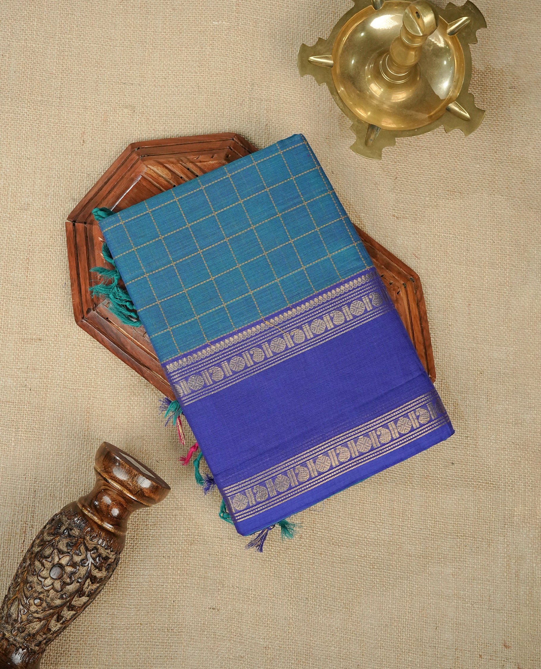 Teal colour chettinad cotton saree Featuring Gold zari Check Pattern on body, complemented by contrast Blue colour with zari border, comes with matching blouse piece.
