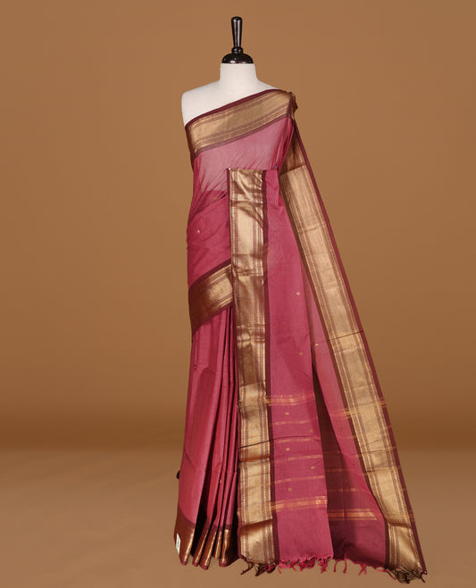 Mauve colour Chettinad cotton saree featuring Gold zari motifs body, complemented by contrast Chocolate Brown colour with gold zari border, paired with matching blouse piece.