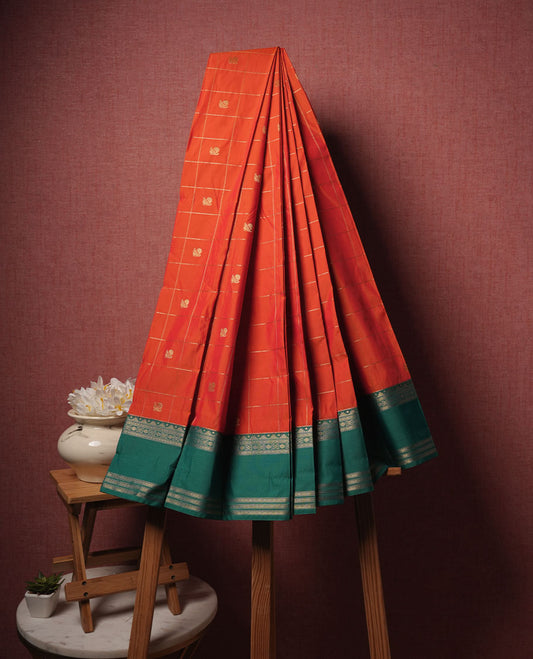 Orange colour semi silk saree highlighting gold zari box pattern  and motifs across body, featuring contrast green colour border with gold zari pattern, comes with matching blouse .