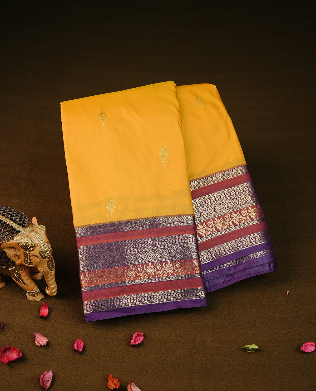 Mustard yellow colour semi wedding silk saree featuring gold zari buttas on body, contrast brown & purple colour traditional border on body, rich pallu comes with matching blouse piece