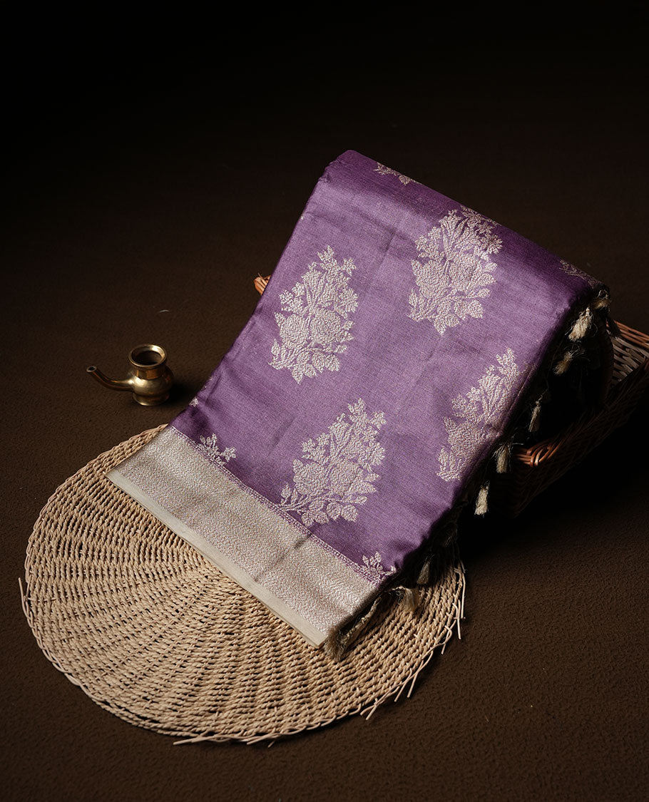Purple colour pure banaras tusser silk saree highlighting antique zari pattern across body, with contrast cream colour with zari border and paired with matching blouse