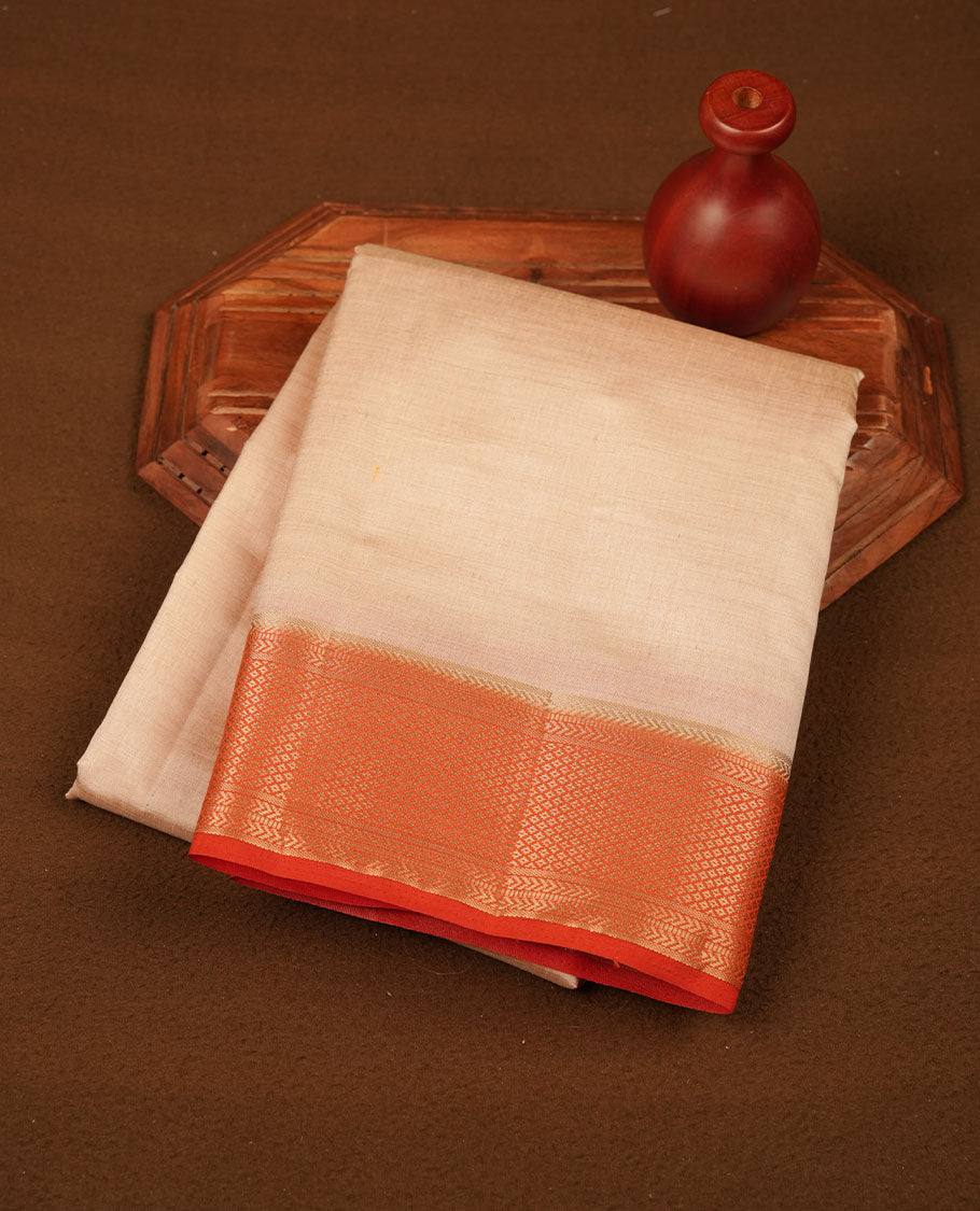 Cream colour tussar silk saree featuring elegant plain body, contrast orange colour border with gold zari, comes with matching blouse piece.