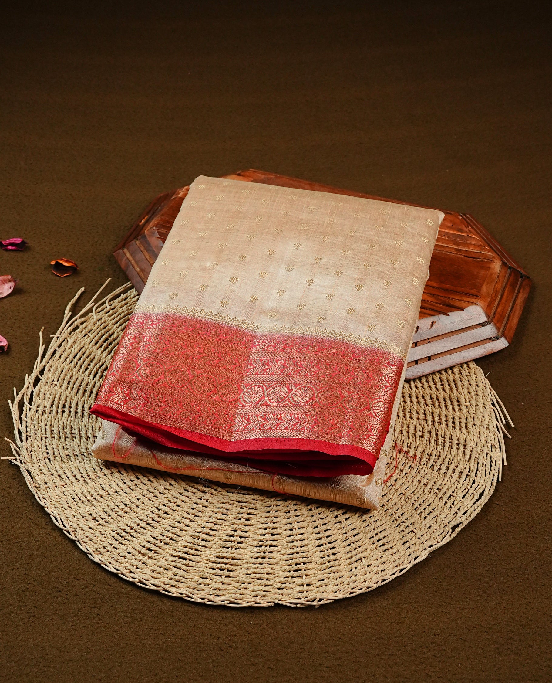 Light gold tussar saree featuring gold zari Buttas, complemented by contrast Red colour with Gold zari traditional border, paired with matching blouse piece.