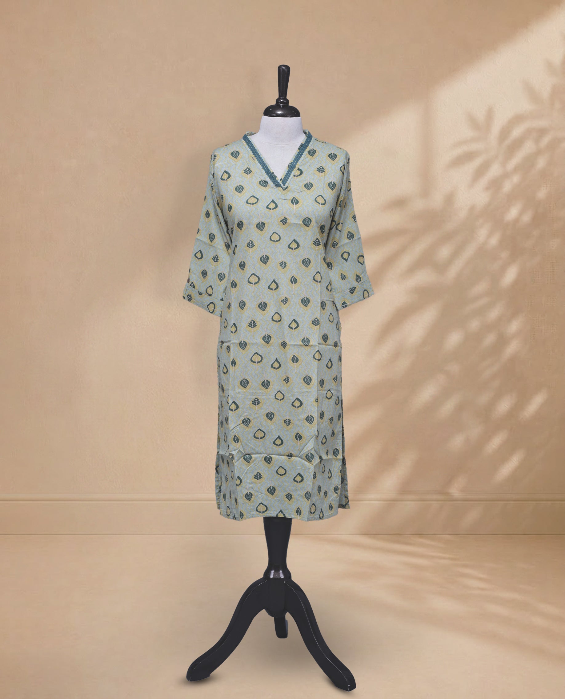 Sea Salt  Colour kurti featuring a classic V-shaped Thread Pattern neckline, Green & Yellow Leaf Prints on the body, and sleeves.