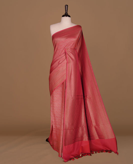 Rani pink colour semi banaras katan saree featuring Gold zari Pattern across body, complemented by self colour with zari border, paired with matching blouse piece.