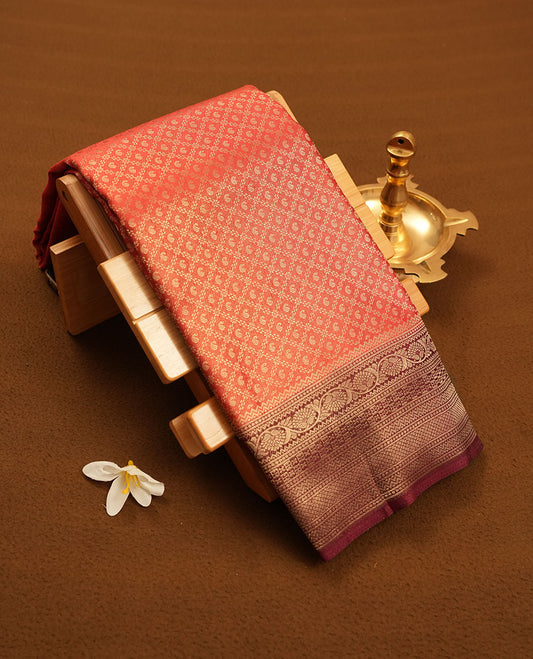 Brick red colour semi silk brocade saree featuring intricate Gold Diamond patterns across the body, complemented by a contrast Brown colour woven border and pallu, paired with a matching blouse.