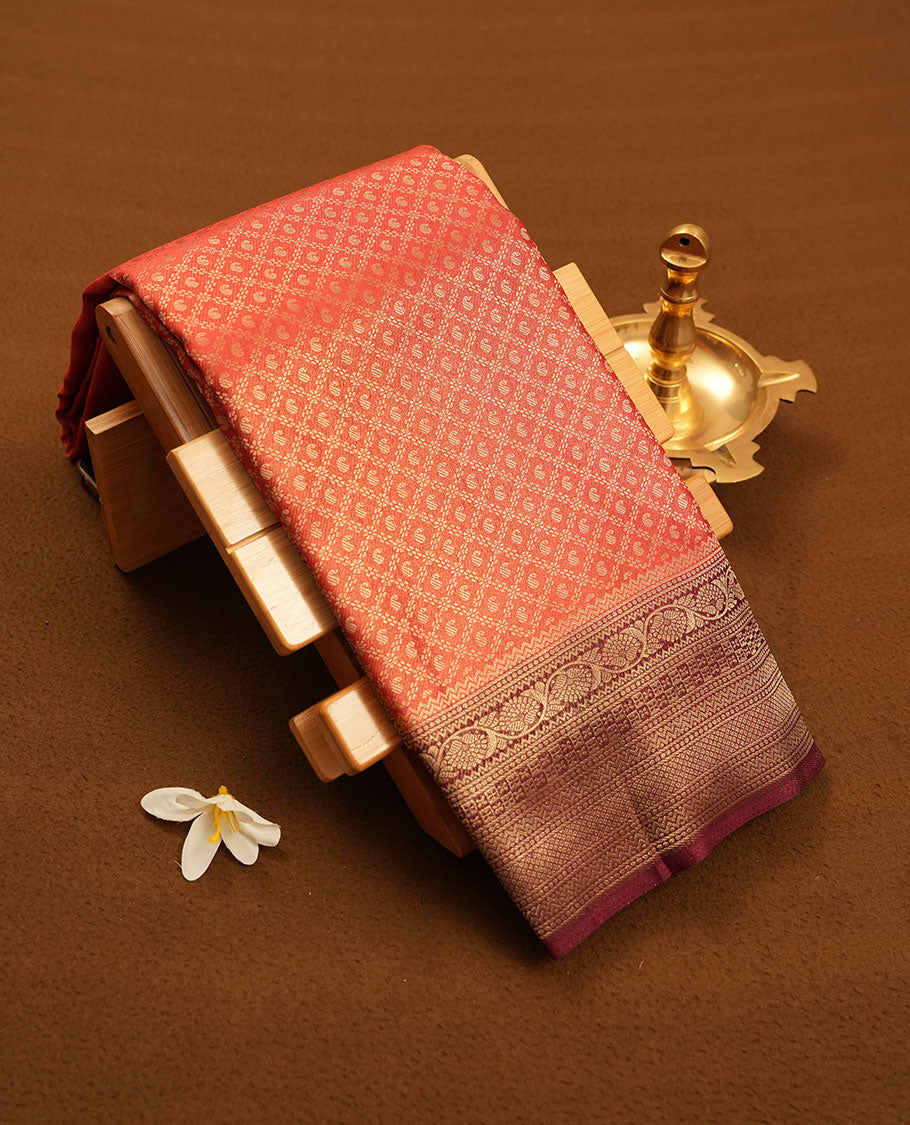 Brick red colour semi silk brocade saree featuring intricate Gold Diamond patterns across the body, complemented by a contrast Brown colour woven border and pallu, paired with a matching blouse.