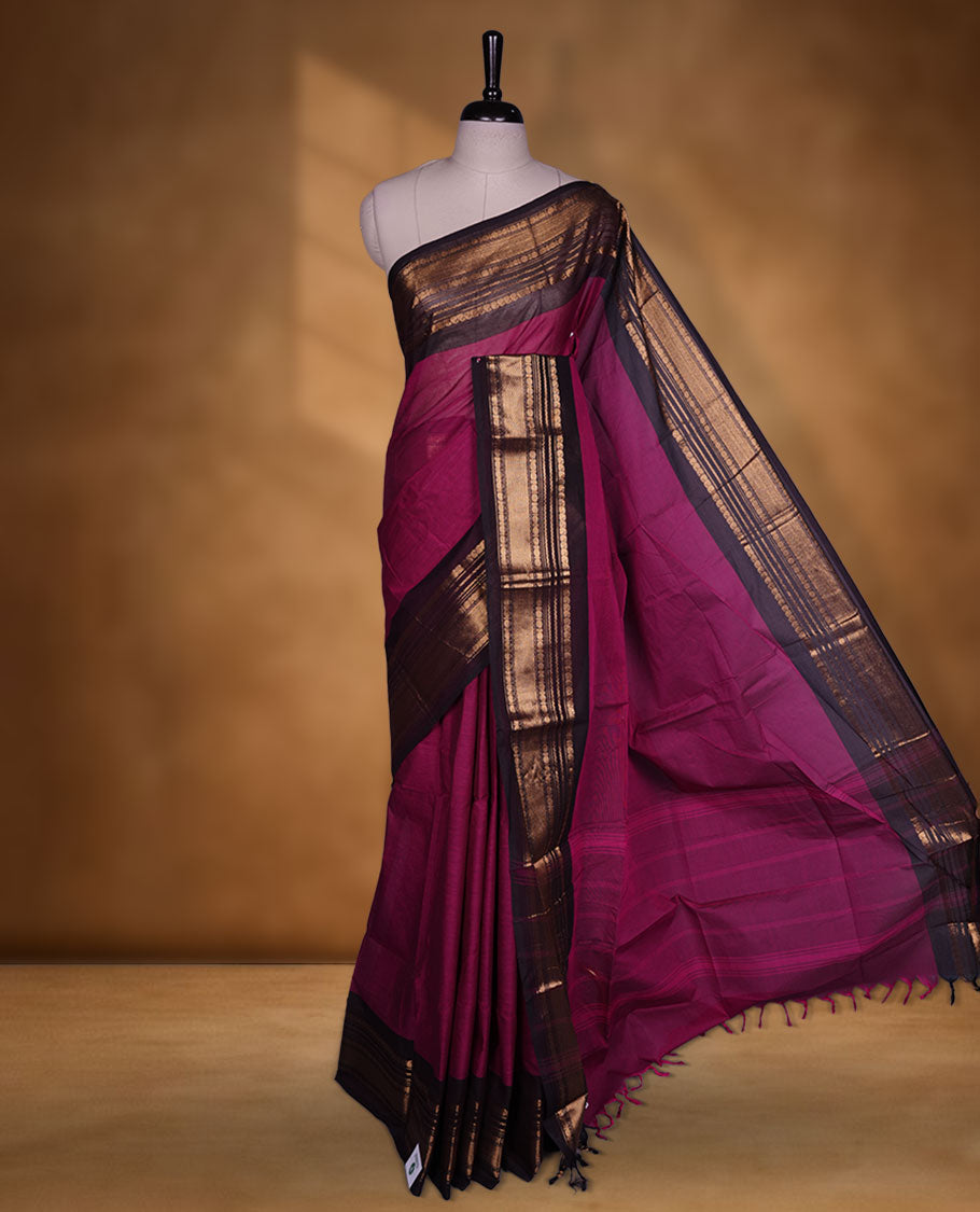 Dark Magenta colour chettinad cotton saree featuring plain body, contrast Dark brown colour with traditional gold zari border paired with matching blouse.