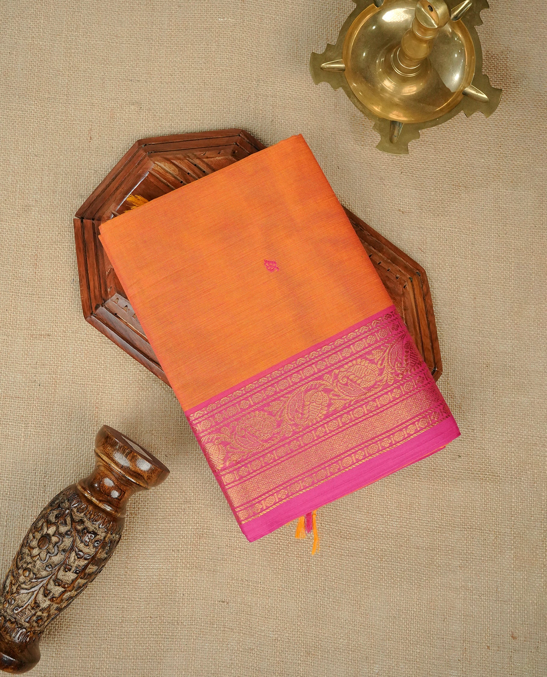 Orange colour Chettinad cotton saree featuring magenta Motifs on body, complemented by contrast magenta colour with Gold zari border, matching blouse piece.
