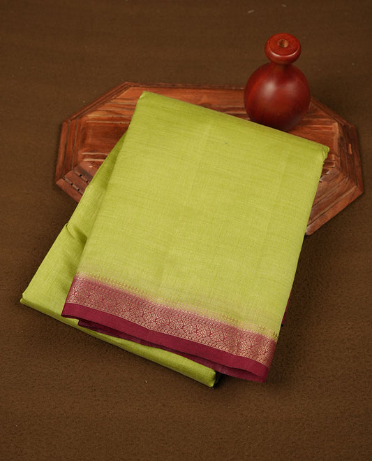 Green colour semi tussar saree featuring elegant plain body, contrast maroon colour gold zari border and comes with matching blouse piece.