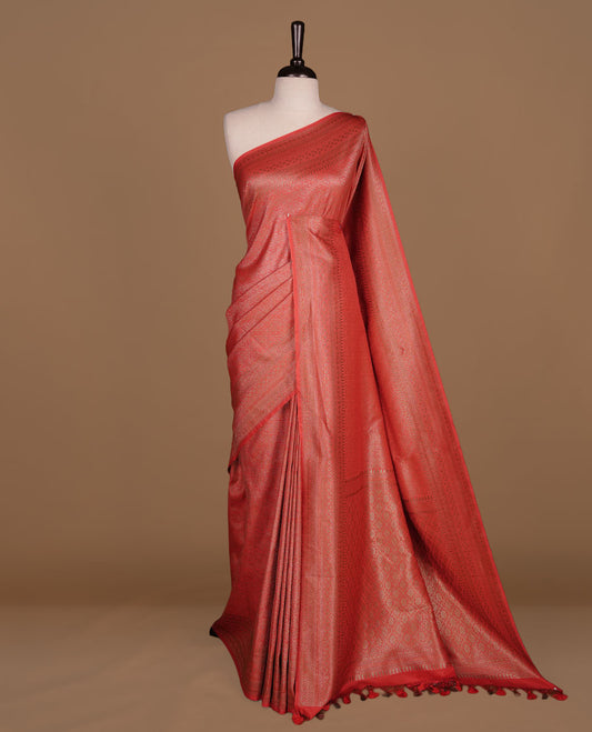 Red colour semi banaras katan saree featuring Gold zari Pattern across body, complemented by self colour with zari border, paired with matching blouse piece.