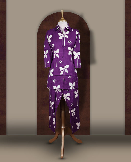 Dark purple colour cord set with bold off white floral prints,Features a collared kurta with front buttons and 3/4 sleeves, paired with matching pants for a trendy and contemporary ethnic look.