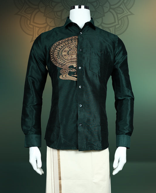 Olive green colour semi silk shirt featuring an exquisite golden Kathakali face fancy print on the chest, styled with a classic collar, full sleeves, and chest pocket, perfect for festive and traditional occasions.