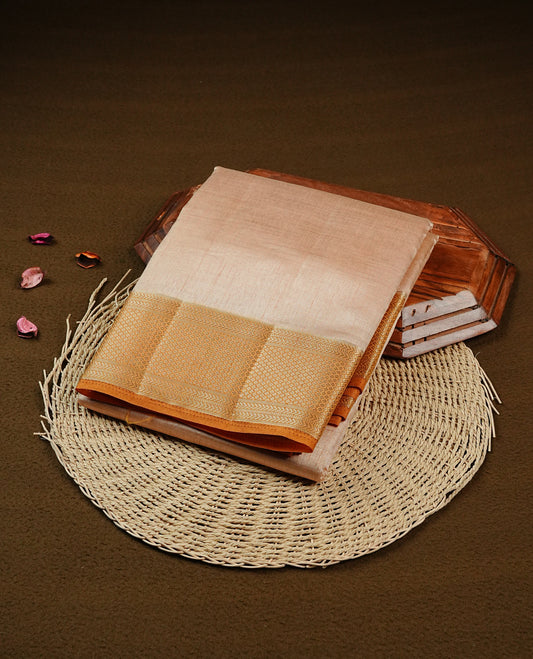 Light Gold Tussar saree featuring Gold zari buttas on body, complemented by contrast Mustard Colour with Gold zari border, comes with matching blouse piece.