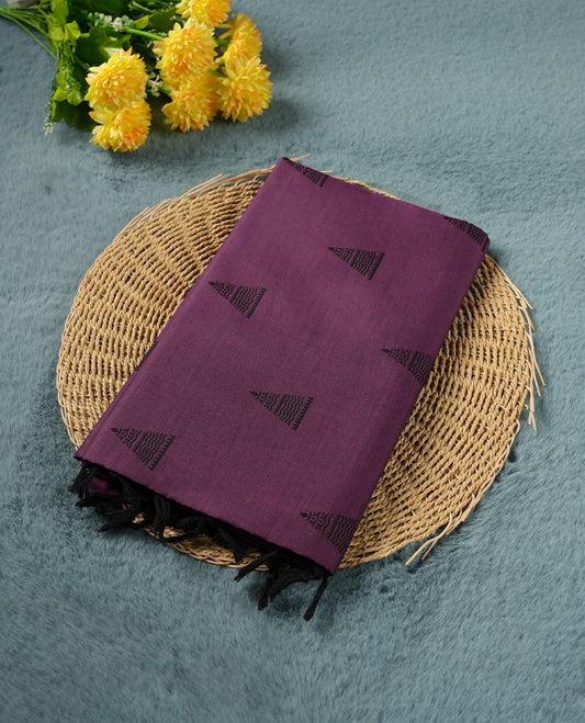 Purple colour poly cotton saree with black temple motifs on the body, paired with a matching with black woven traditional border, and a coordinated all‑over geometric printed blouse piece.