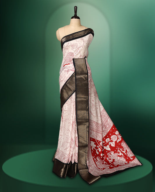 off white colour saree adorned with intricate red Kalamkari style motifs, complemented by a bold red pallu featuring traditional designs, and finished with a rich black woven border, paired with a matching blouse