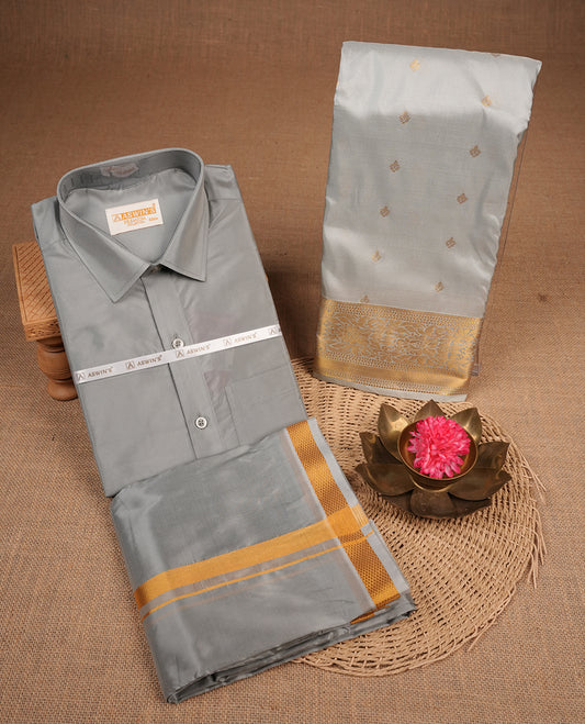 Grey colour shirt and dhoti with gold colour border, paired with matching colour silk saree featuring gold zari buttas and traditional border paired with matching blouse piece.