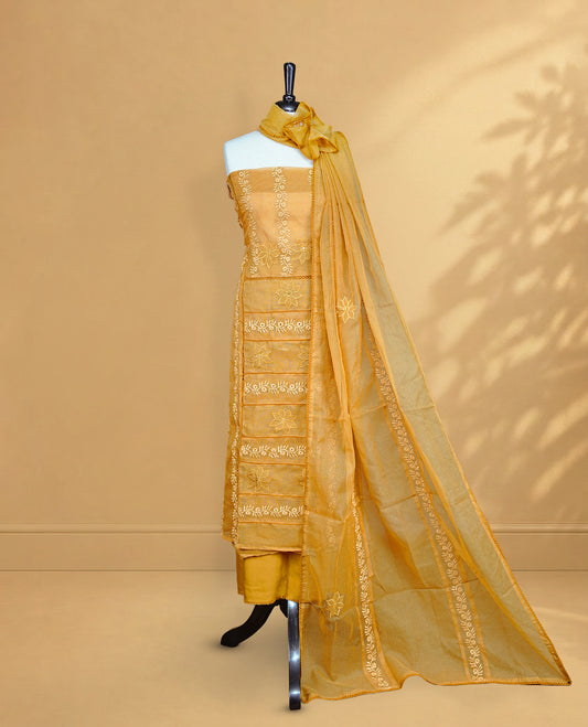 Mustard colour Salwar material featuring Self colour Floral Thread pattern, Matching bottom and paired with Same colour with thread patterned Dupatta.