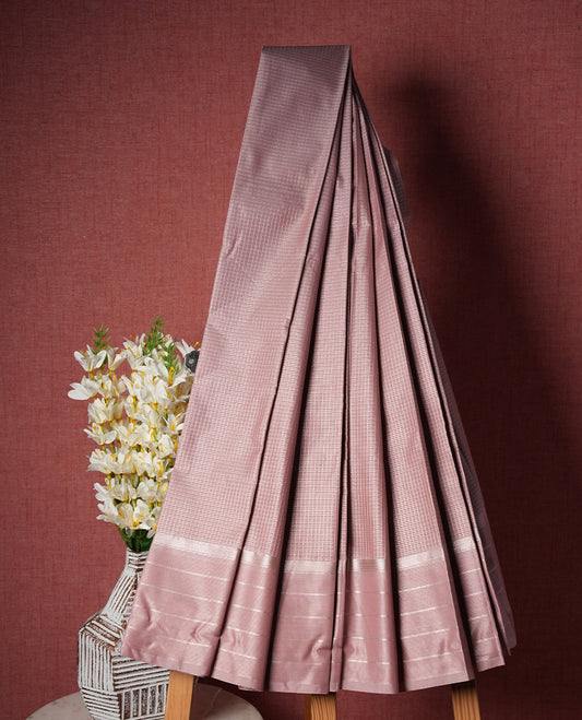 Dusty pink colour Semi Silk Saree with silver zari striped patterns on the body, paired with a Self coloured traditional pallu and border, and a matching blouse piece.