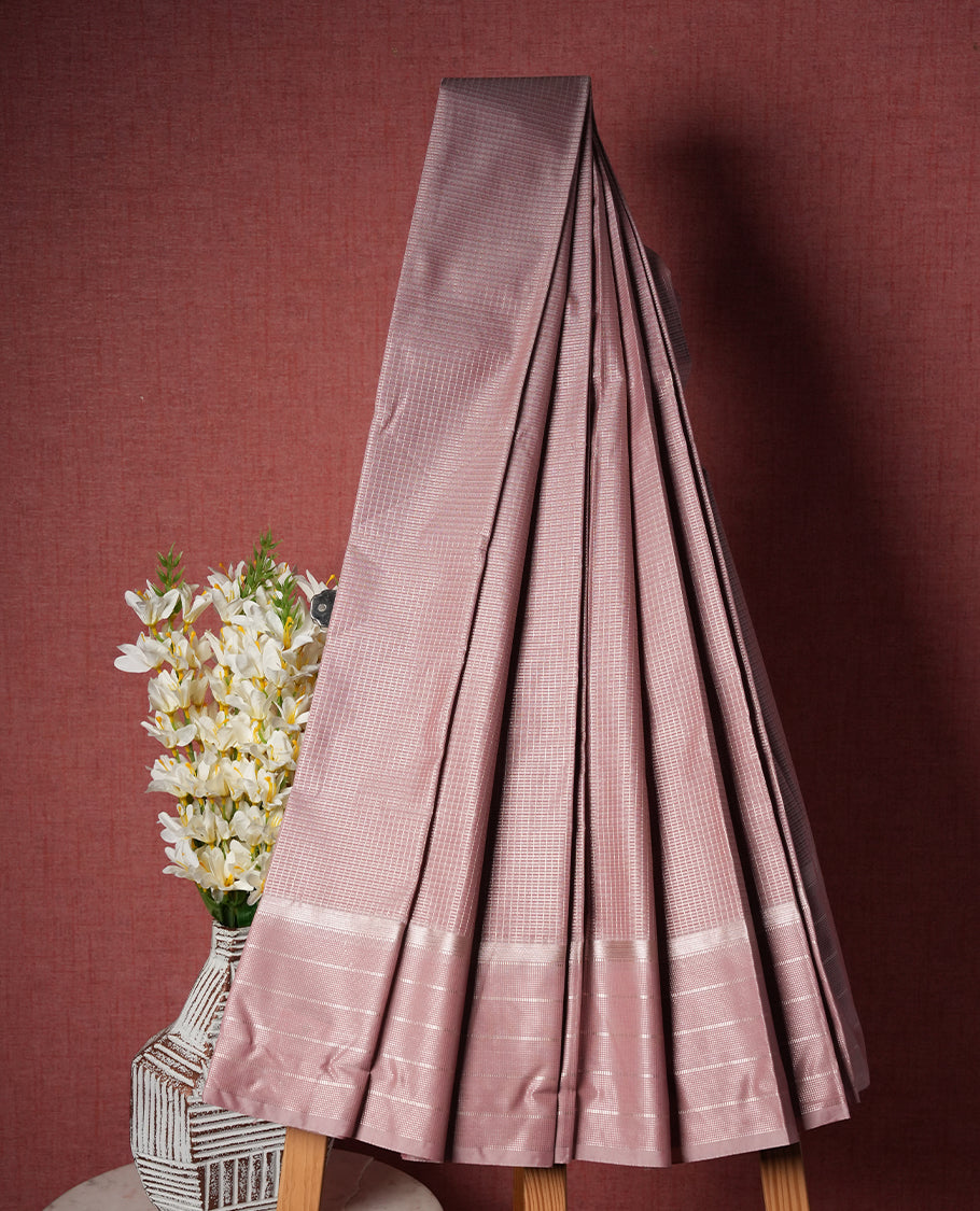 Dusty pink colour Semi Silk Saree with silver zari striped patterns on the body, paired with a Self coloured traditional pallu and border, and a matching blouse piece.