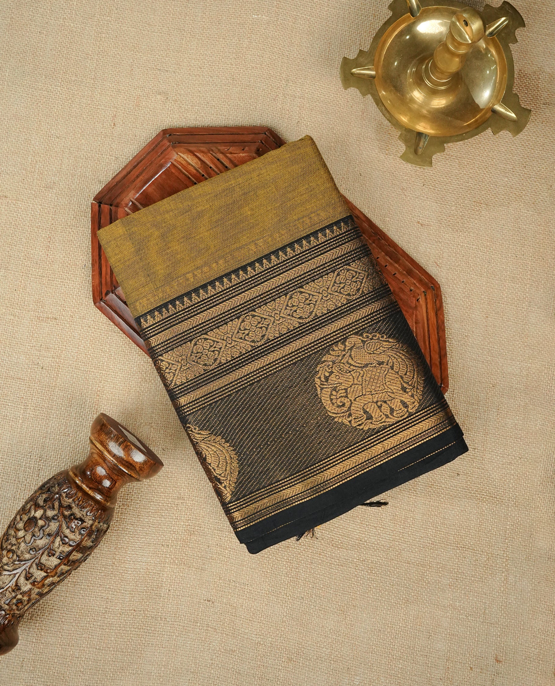 Olive colour chettinad cotton saree featuring Elegant plain body, Contrast black colour with gold zari border, comes with matching blouse piece.
