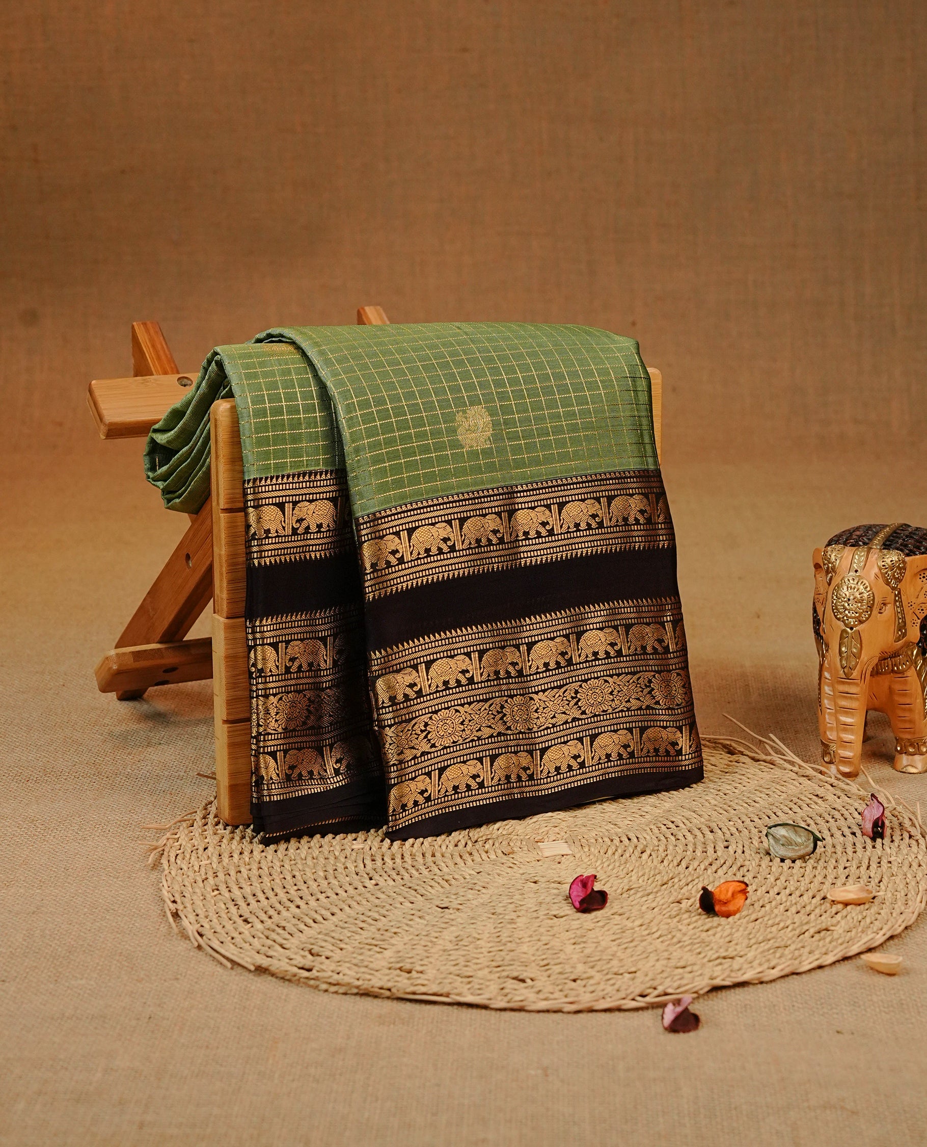 SeaForm Green colour Kancheepuram silk saree featuring Gold zari check with Chakra Motifs on body, complemented by chocolate colour with Traditional border, comes with matching blouse piece.