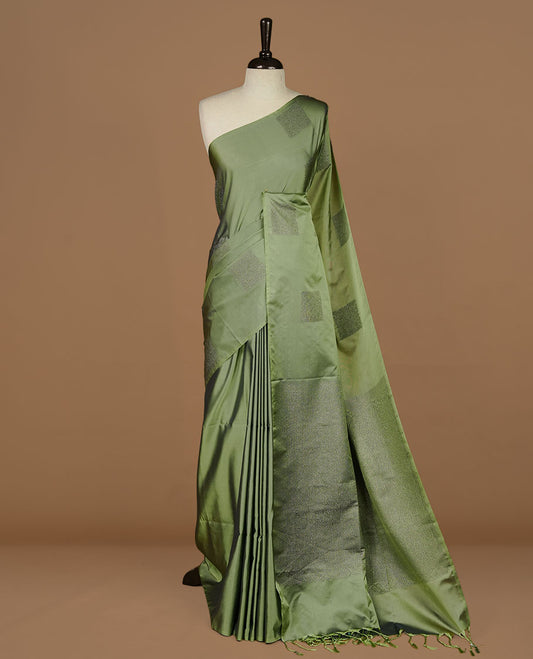 Seafoam green soft silk saree features a sleek borderless design with intricate antique zari motifs, flowing into a seamless self colored pallu and a matching blouse piece.