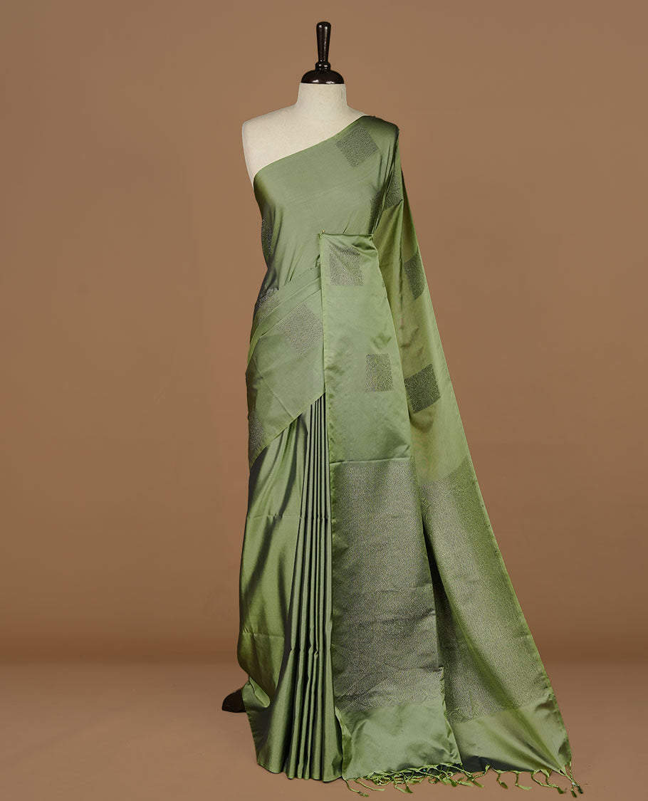 Seafoam green soft silk saree features a sleek borderless design with intricate antique zari motifs, flowing into a seamless self colored pallu and a matching blouse piece.