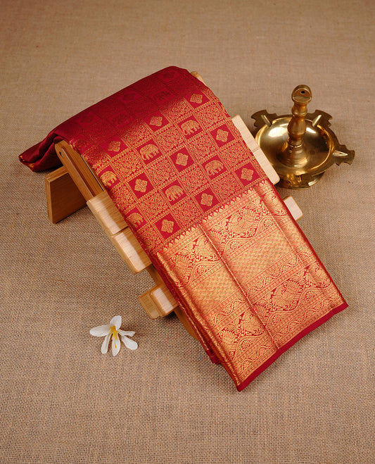 Maroon colour kancheepuram silk saree featuring gold zari check pattern across body, complemented by selfcolour border traditional zari border, paired with matching blouse piece.