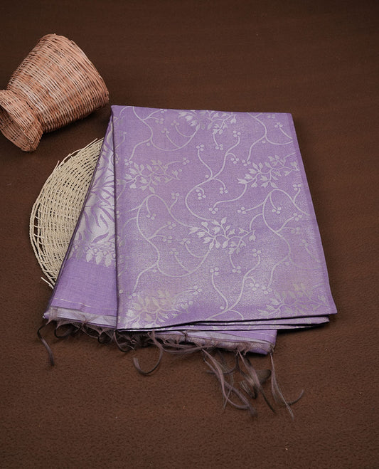 Lavender colour semi tussar silk saree, featuring an intricate gold zari floral kodi pattern on the body and pallu, comes with matching blouse.