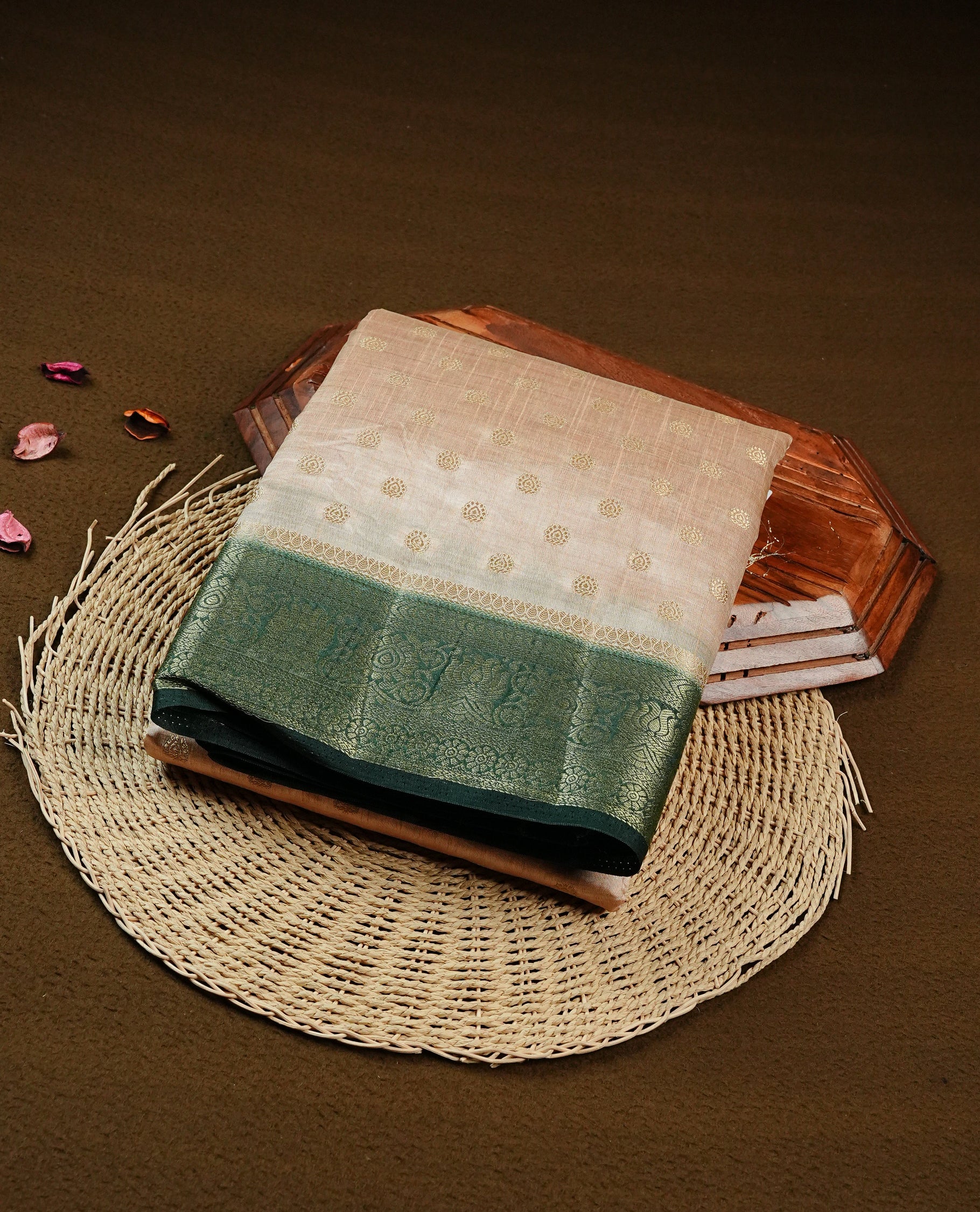 Light Gold Tussar saree featuring Gold zari buttas on body, complemented by contrast dark green Colour with Gold zari border, comes with matching blouse piece.