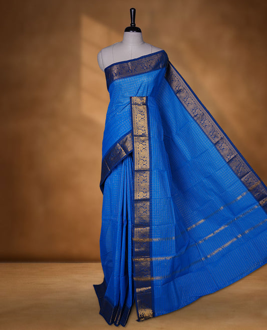 Blue colour chettinad cotton saree featuring gold zari check patterned body, paired with a dark blue colour traditional gold zari border without blouse.
