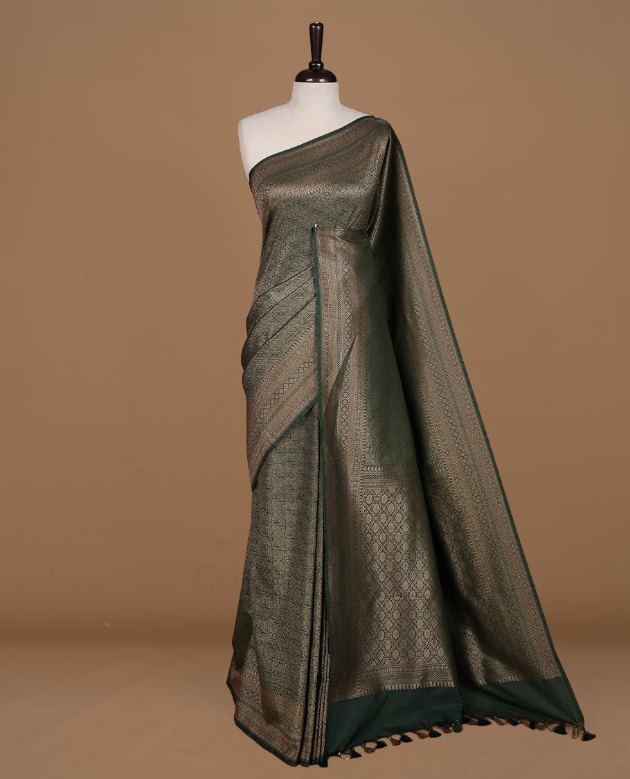 Green colour semi banaras katan saree featuring Gold zari Pattern across body, complemented by self colour with zari border, paired with matching blouse piece.