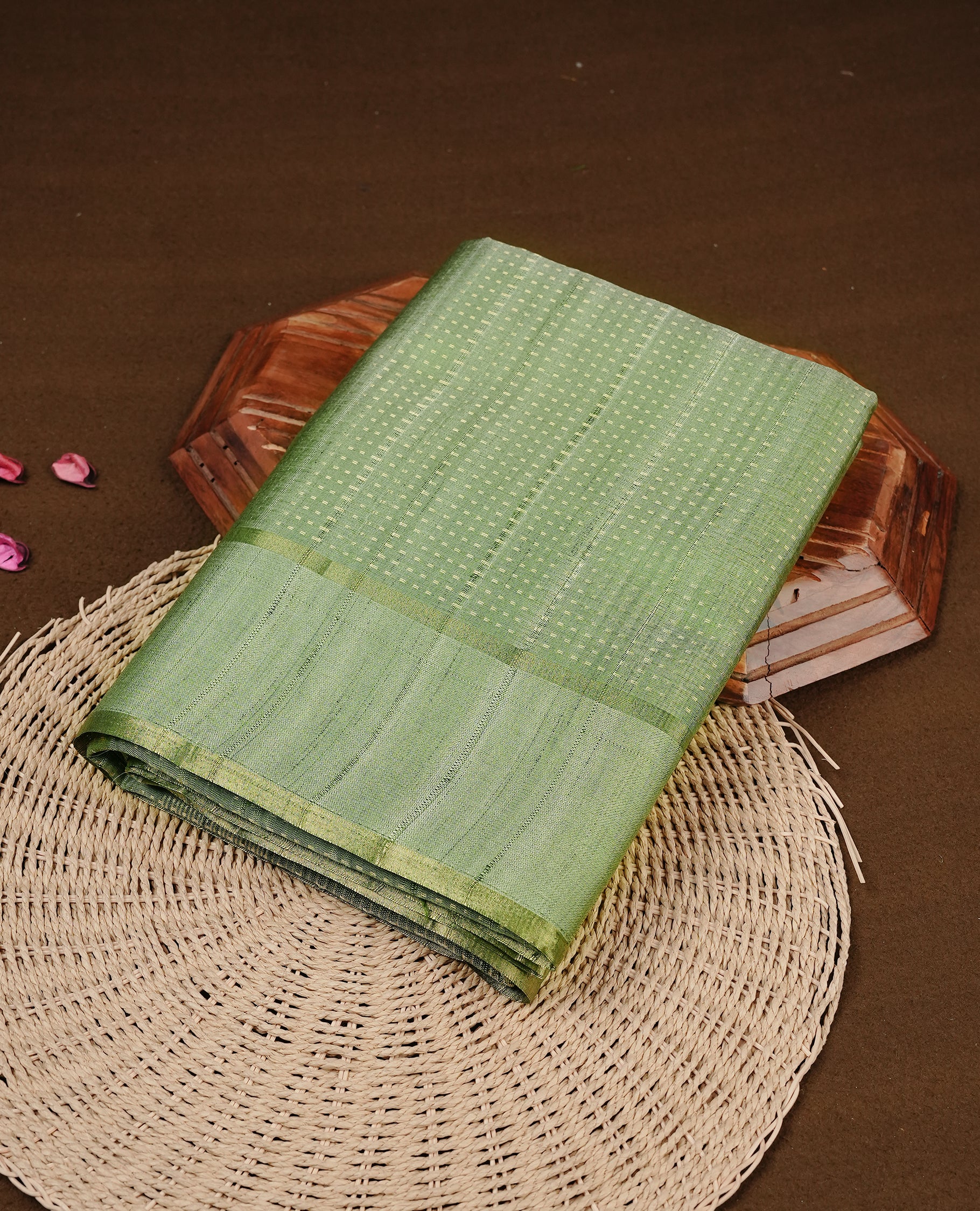 Light jade colour semi tussar silk saree featuring elegant gold zari dotted stripes across the body, enhanced with a rich zari woven border. Comes with a matching blouse piece.