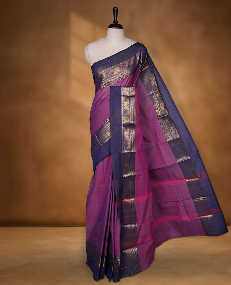 Purple colour chettinad cotton saree featuring plain body, contrast Navy blue colour with traditional gold zari border without blouse.