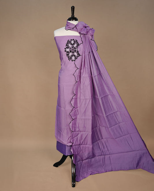 Pastel purple colour churidari material featuring black thread pattern on body, paired with matching bottom and dupatta
