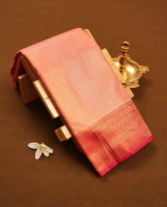Pink colour semi silk brocade saree featuring intricate Gold Floral kodi & leaf patterns across the body, complemented by a contrast Magenta colour woven border and pallu, paired with a matching blouse.