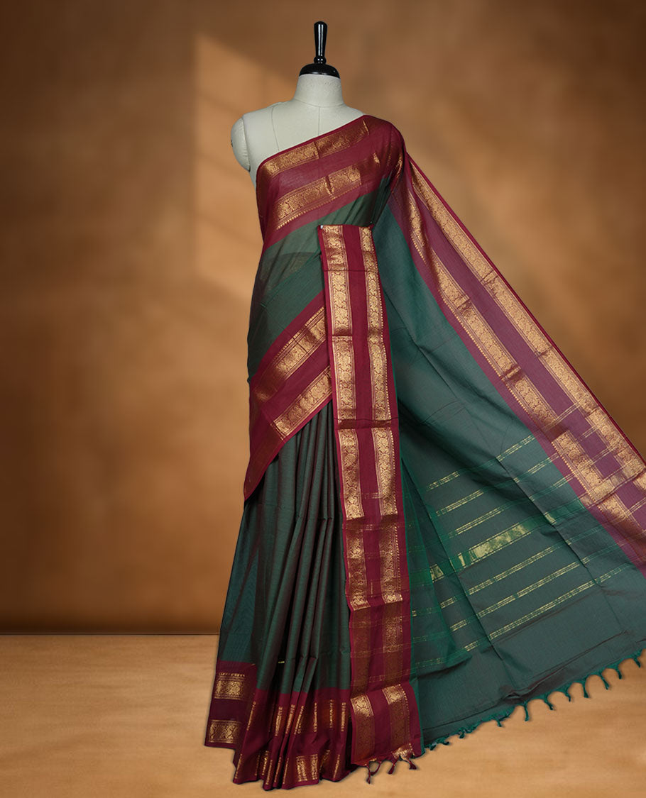 Dark Green colour chettinad cotton saree featuring Elegant plain body, contrast Red colour border with gold zari border, pallu and paired with matching blouse.
