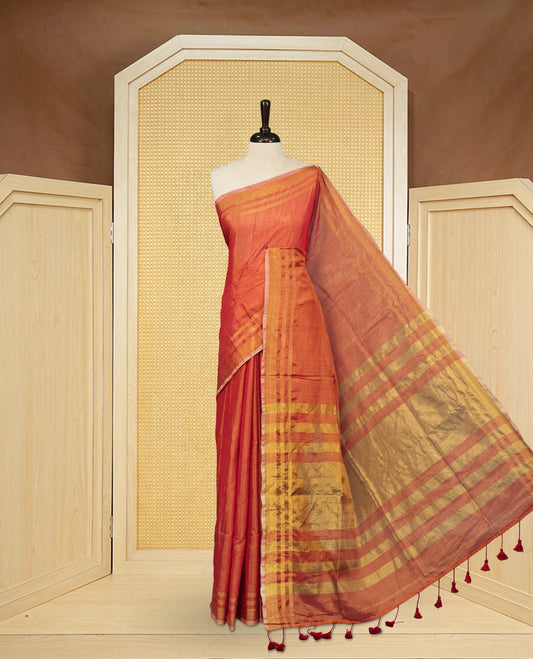 Red colour Semi Tissue Silk saree featuring Elegant plain body, Enhanced with Gold tissue Border & Striped Pallu & beautiful Tassels for Elegant Prefect Look.
