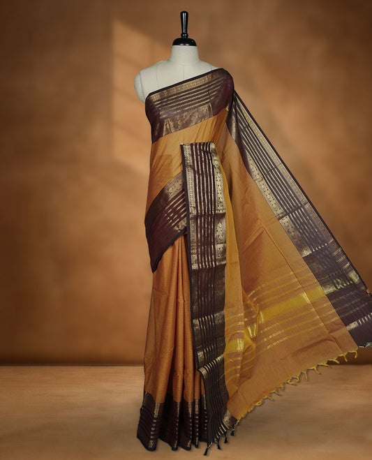 Dusty orange colour chettinad cotton saree featuring plain body, paired with a choclate brown colour traditional gold zari border paired with matching blouse.