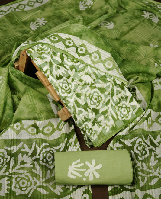 Green colour churidar material featuring white floral printed body, paired with a matching chevron printed dupatta.