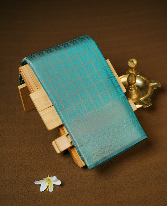 Bottle Green colour Semi Wedding silk saree featuring gold zari Check pattered body, complemented by self colour with traditional border, paired with matching blouse piece.