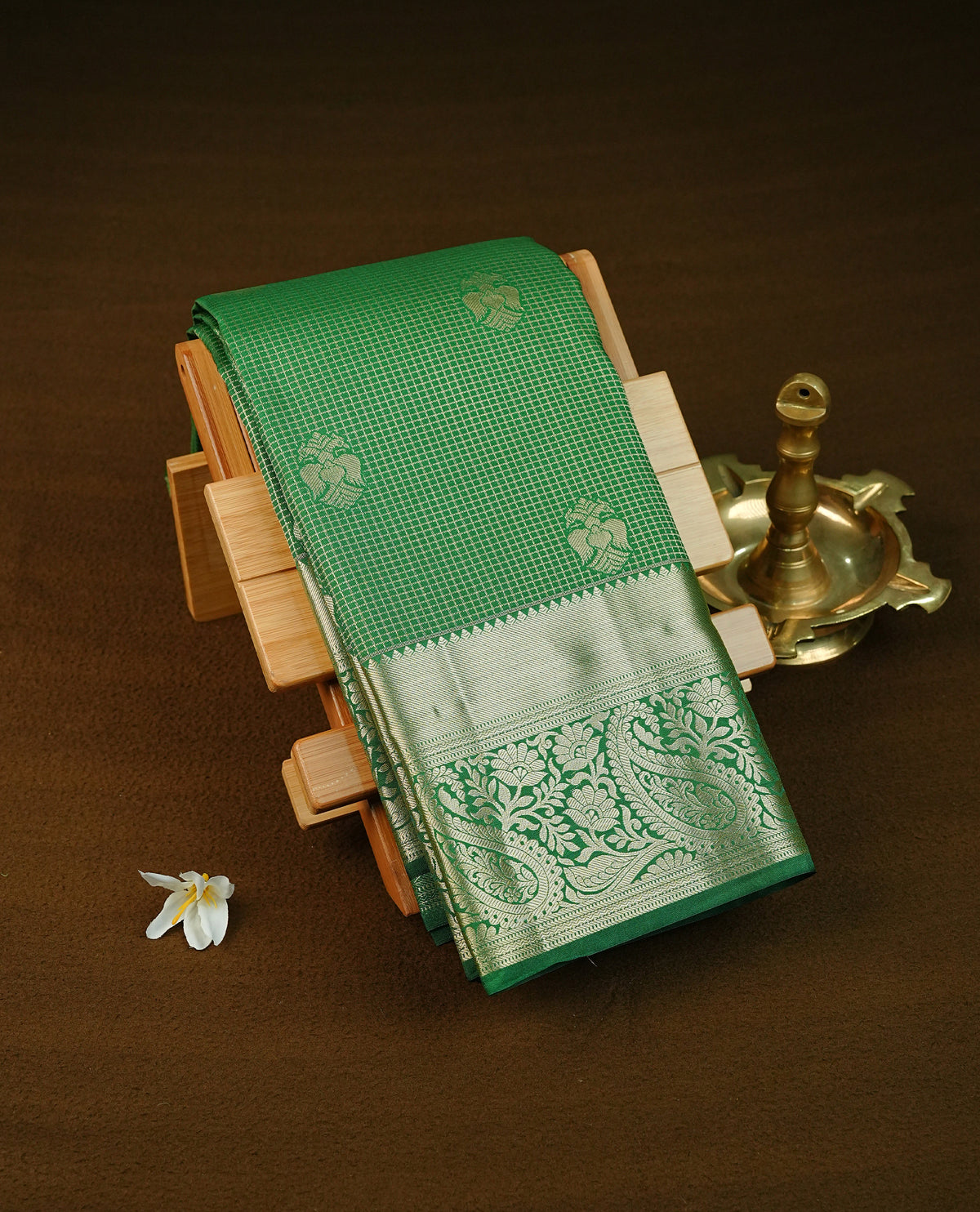 Green colour semi wedding saree featuring gold zari check with  motifs on body complemented by Self colour with traditional border, comes with matching blouse piece.