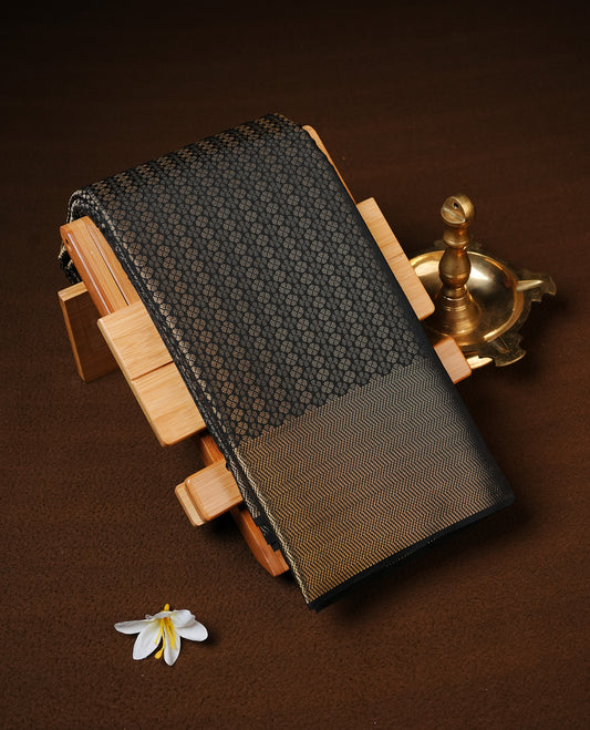 Black Colour Semi Wedding Silk Saree Featuring Gold Zari Floral Stripes On Body, Adored With Self colour With Traditional Border, Paired With Matching Blouse Piece.