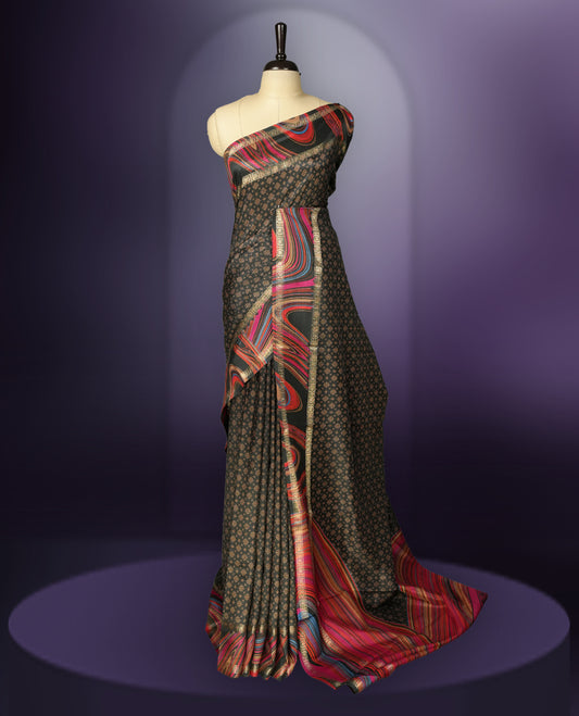 Black colour saree enhanced with a vibrant golden border and multiple colour prints pallu, adorned with intricate golden floral colour prints on the body & comes with a matching blouse.