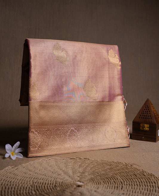 Dual tone light peach and pink colour tissue brocade saree featuring antique gold zari motifs on the body with a rich traditional zari border and pallu, paired with a matching blouse piece.