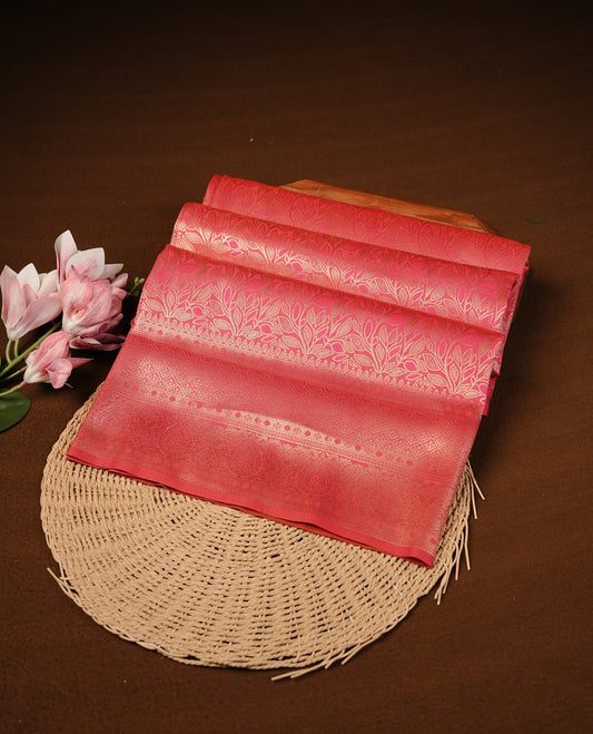 Rani Pink Colour Softie Silk Saree Featuring An All Over Gold Woven Leaf Pattern, Finished With A Matching Border Adorned With Intricate Paisley And Floral Motifs, Paired With A Matching Blouse Piece.