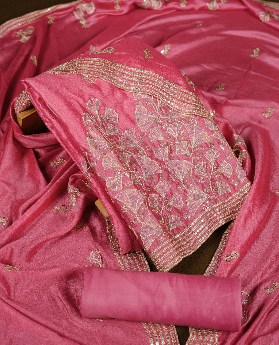 Pink colour churidar material with subtle mirror and thread embroidery, finished with delicate border detailing and paired with a matching plain bottom and dupatta.